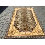 A wool rug, with leopard print centre and Greek key border, 253 cm x 160 cm