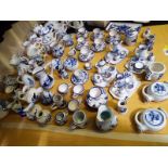 A large quantity of Delft ornamental table ware to include miniature tea-sets, jugs and similar