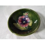 A Moorcroft Pottery small pedestal bowl decorated with pansy on a green ground, 4 cm (high) x 8.8