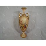 A Royal Worcester twin handled vase with floral decoration, gilt highlights on a blush ivory