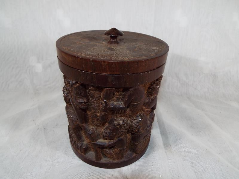 A wooden highly carved caddy 14cm (h)