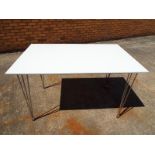 A modern dining table with white table top and chrome legs 71 cm  x 121 cm x 76 cm