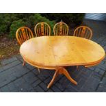 A good quality pine oval dining table with four chairs, when extended table measures 79cm x 150cm x