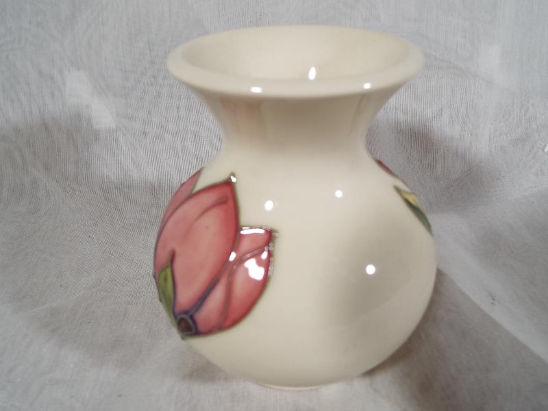 Moorcroft Pottery - A vase decorated with pink magnolia on an ivorine ground, 9cm (h) - Est £40 - - Image 2 of 2