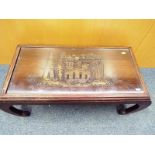 A Malaysian ornately carved occasional table with glass top, 36 cm x 80 cm x 38 cm