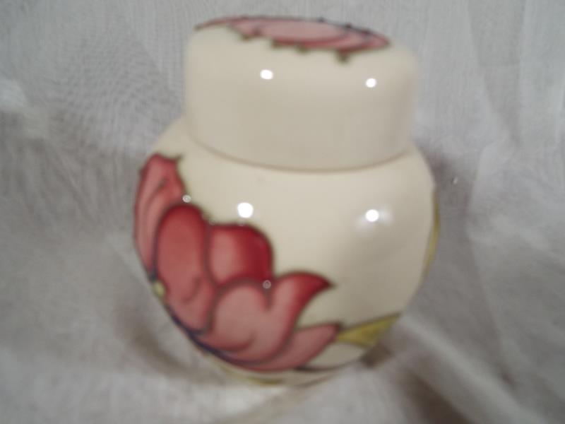 Moorcroft Pottery - A lidded ginger jar decorated with pink magnolia on an ivorine ground, 10.5cm - Image 2 of 2