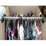 A transporter clothes rail containing a collection of good quality lady's clothes to include