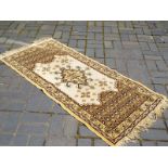 A carpet runner, cream and brown with fringed ends approximate length 160 cm x 75 cm