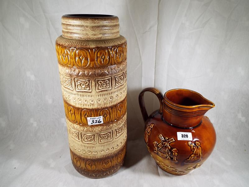 An Arthur Wood six pint Lambeth jug with relief decoration 22 cm (h) and a West German cylindrical