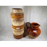 An Arthur Wood six pint Lambeth jug with relief decoration 22 cm (h) and a West German cylindrical