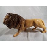 A Beswick pottery figurine depicting a lion facing right - 1506, 13.3 cm (h) - Estimate £30 - £50