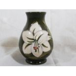 A Moorcroft Pottery small vase decorated with Bermuda Lily on a green nground, 9 cm - Est £50 - £60