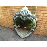 An ornate bevil edged wall mirror in the shape of a heart, approximately 104 cm (h) x 80 cm (w)