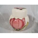 Moorcroft Pottery - A lidded ginger jar decorated with pink magnolia on an ivorine ground, 10.5cm