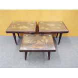 Three Malaysian carved tables with glass tops, largest table measures 40cm x 47cm x 32cm, the