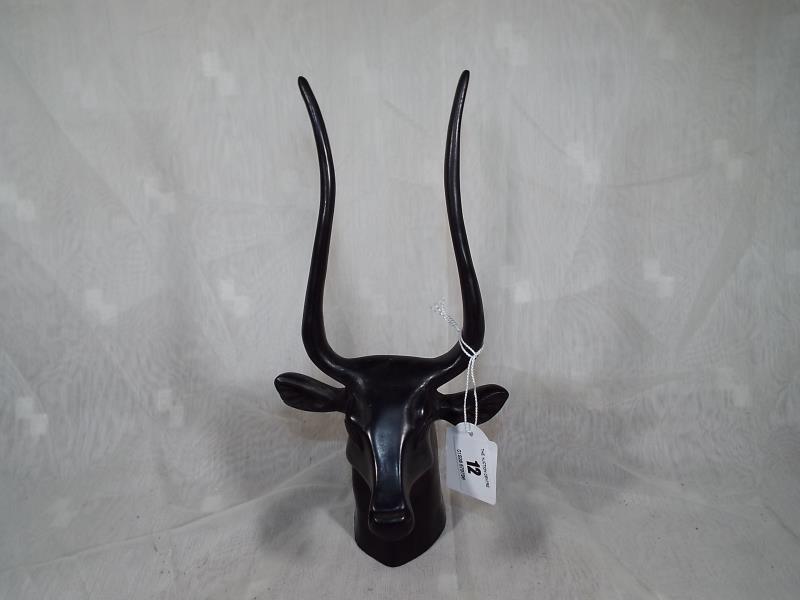 A good quality figurine depicting an Egyptian bull, bearing scribed symbol on neck, 27 cm (h)