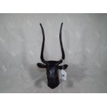 A good quality figurine depicting an Egyptian bull, bearing scribed symbol on neck, 27 cm (h)