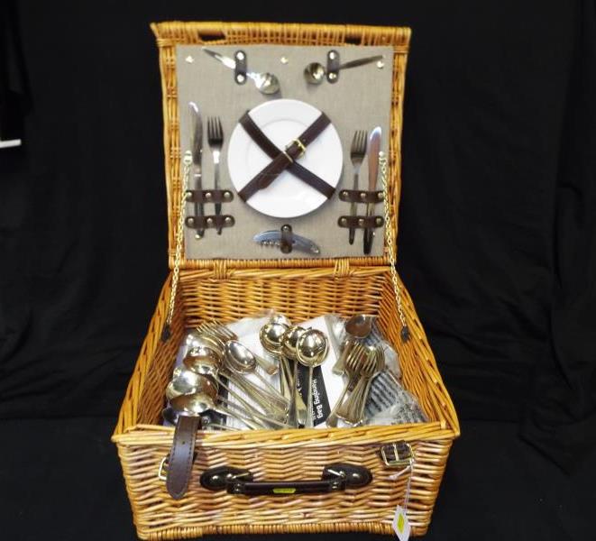 A good quality wicker picnic basket containing a two place setting ceramic tableware set, a