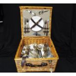 A good quality wicker picnic basket containing a two place setting ceramic tableware set, a