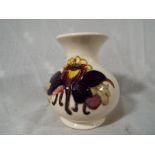 Moorcroft Pottery - A Moorcroft POttery bulbous vase decorated with columbine on a cream ground