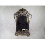 An art nouveau style mirror with silvered frame, 47 cm (h) x 28 cm (w)