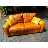 A good quality leather 2 seater sofa, light tan, 80 cm (h) x 200 cm (w) x 100 cm (d)