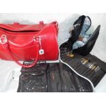 A lady's red bag, a bear essentials travel brush set with matching wash bag, an Amanda Lamb beauty