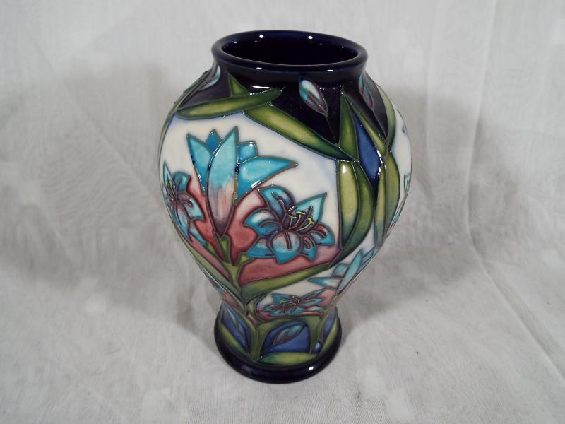 Moorcroft Pottery - A modern baluster vase decorated in a floral design, 16.5cm (h) - Est £100 -