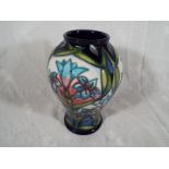 Moorcroft Pottery - A modern baluster vase decorated in a floral design, 16.5cm (h) - Est £100 -