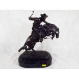 A bronze figurine depicting cowboy on horse back mounted marble plinth,