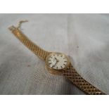 A lady's 9 carat gold cased automatic wristwatch by Omega, total weight 21g,