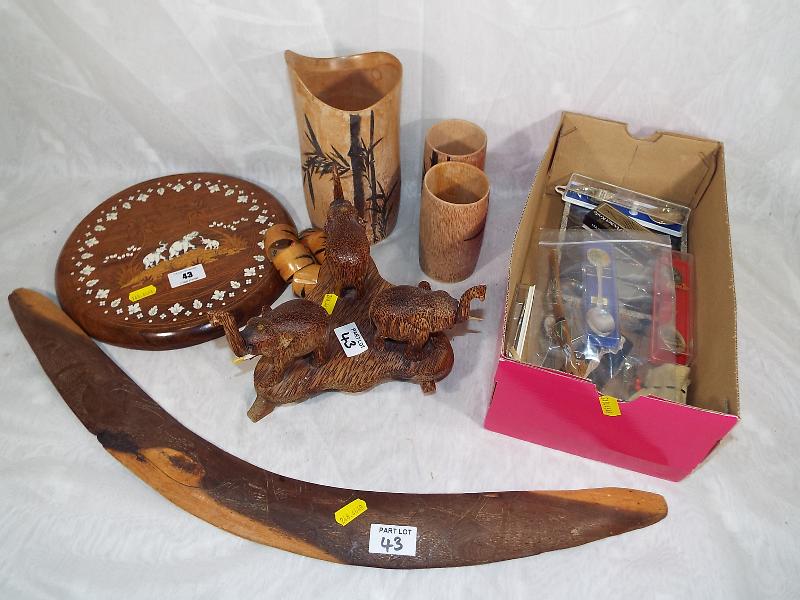 A good mixed lot to include African carved elephants, wall plaque with inlaid decoration, boomerang,