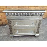 An ornate silvered bedside cabinet with twin drawers faceted glass handles and plate glass surface