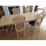 An ornate extending dining table, two carvers and four dining chairs,