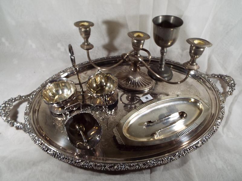 A collection of plated ware to include a large twin handled salver, sauce stand,