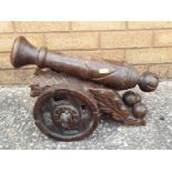 An ornamental carved wooden canon 28 cm (h) x 40 cm (l)