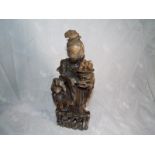 A hard stone carved oriental figure depicting a lady and child 30cm (h)