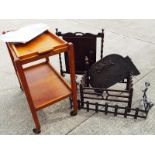 A wooden tea trolley with integral tray,