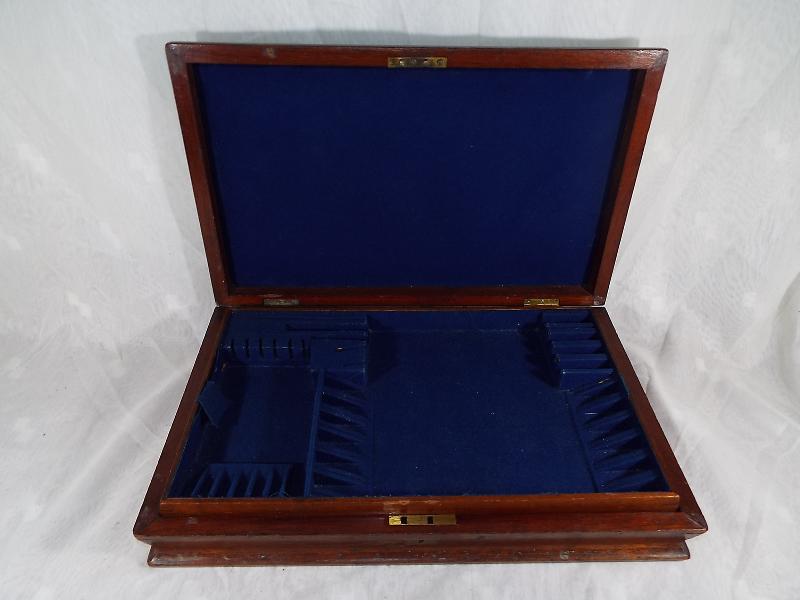 A mahogany cased canteen of cutlery,