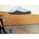 A large patio parasol on adjustable stand