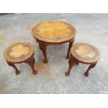 A ornately carved occasional table with claw feet