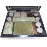 A Victorian walnut dressing table vanity set with fitted compartments containing glass bottles,
