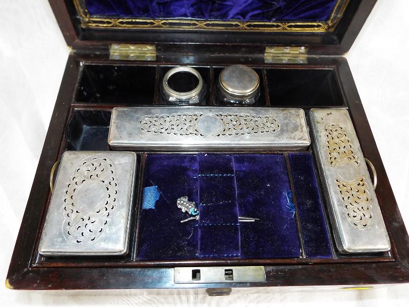 A mahogany cased vanity set with wooden partitions and glass trinket dishes with plated lid - Est