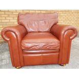 A tan coloured leather chair approximately 96cm (h) x 96cm (w) x 90cm (d)