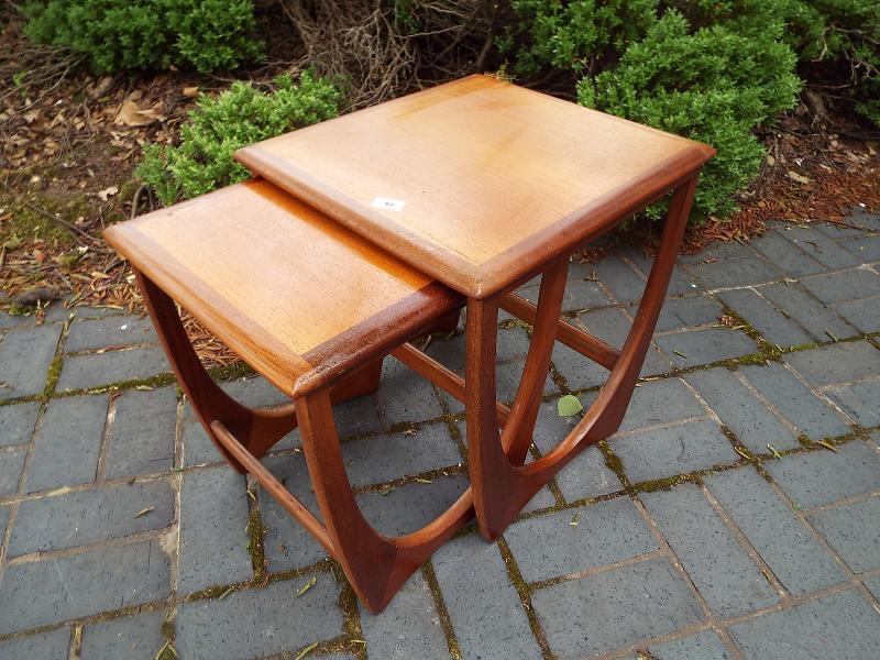 A G Plan nest of two teak tables, adhered red label underneath,