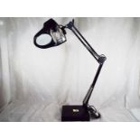 An adjustable desk lamp with magnifier