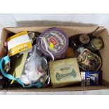 A collection of vintage tins and vintage haberdashery items to include buttons and cottons.