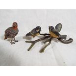 A hand painted cold cast bronze in the form of a grouse and a cold cast bronze depicting birds sat