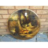 A black lacquered paper mache wall plaque with hand painted front depicting a woodland scene with