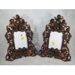 A pair of copper picture frames depicting cherubs overall size 36cm x 26cm (2)